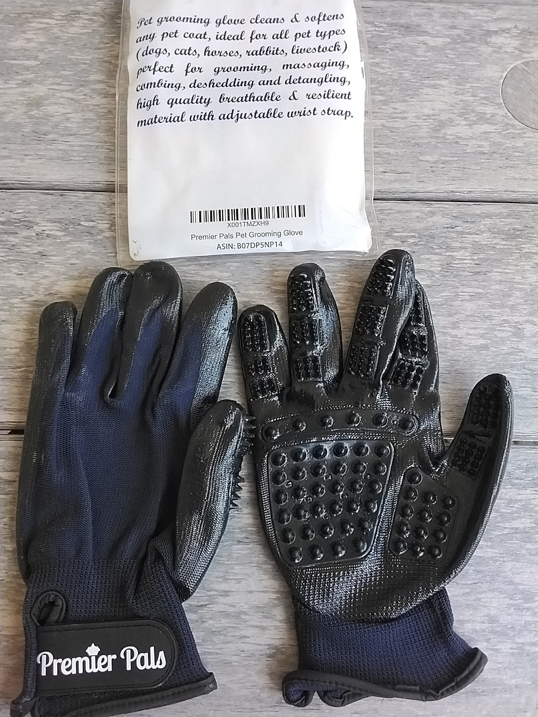 Pair of black grooming gloves with textured palm and 'Premier Pals' brandin. 