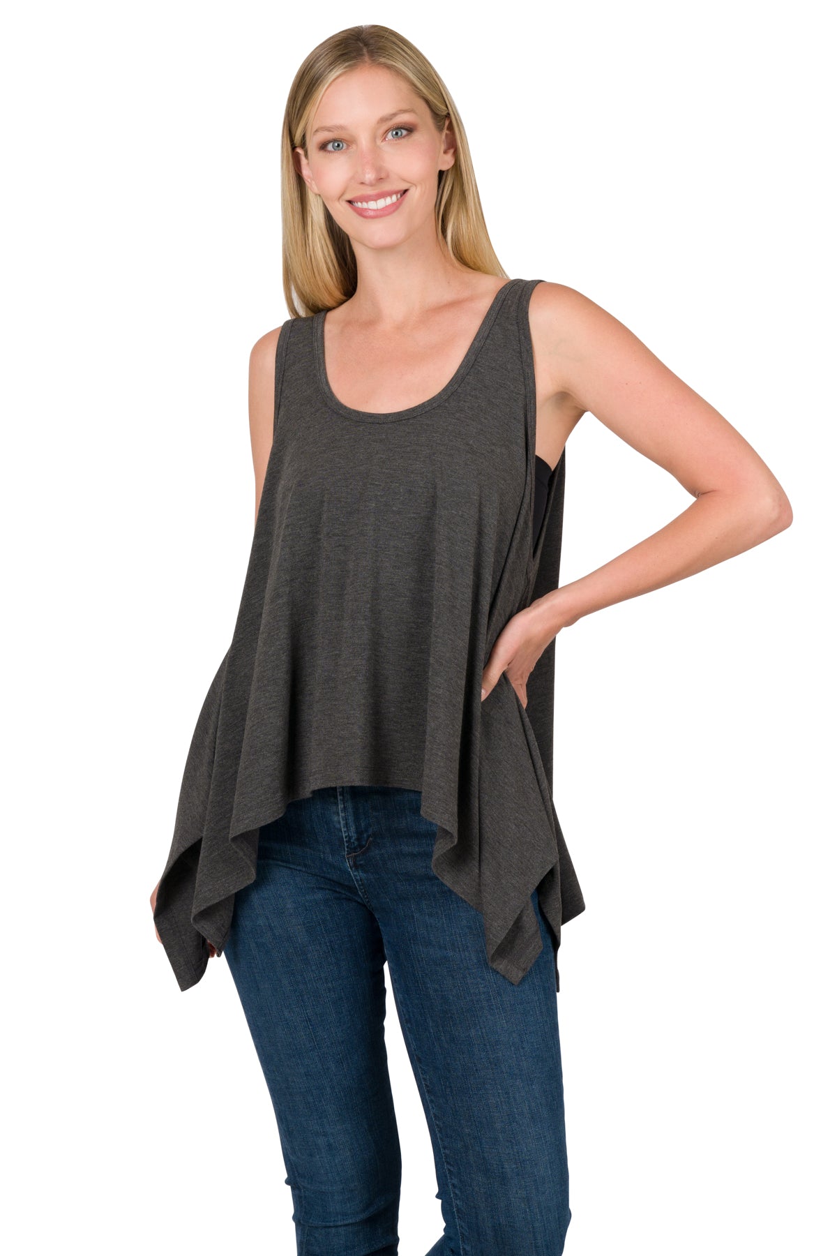 Woman wearing a dark gray sleeveless top and blue jeans on a white background