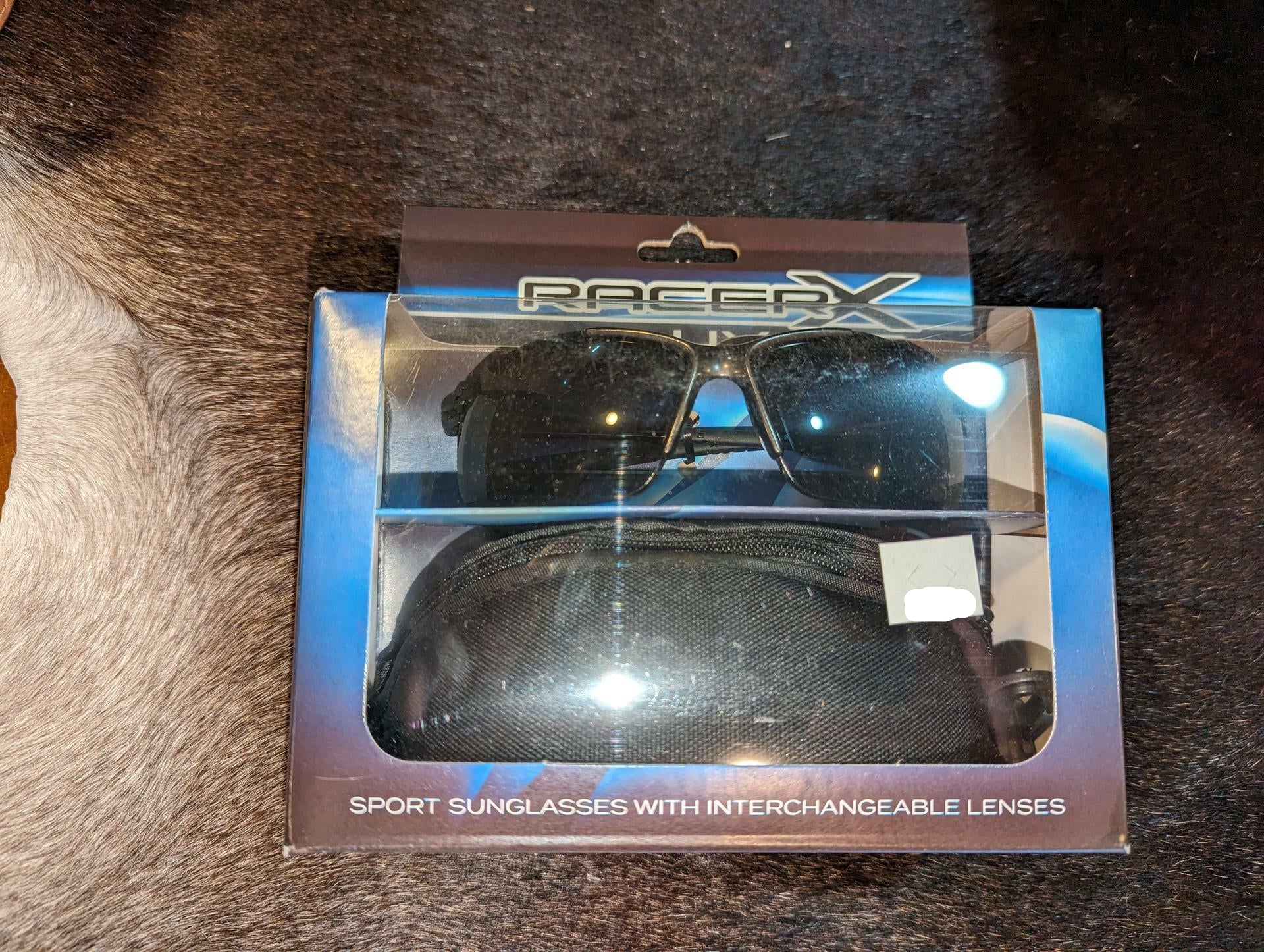 RacerX grey sunglasses in packaging with black carrying case