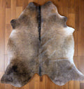 Genuine brown cowhide rug – authentic Grade A leather hide shown in photo, ideal for rustic or Western home decor