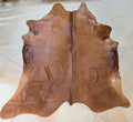 Reddish-Brown Cowhide rug on a tile floor