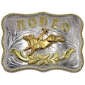 Two-tone Western belt buckle featuring a gold cowboy riding a bull surrounded by silver floral engraving and gold rope trim.