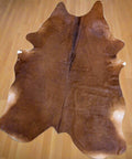 Genuine red cowhide rug with natural texture and rich color