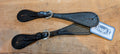 A pair of dark oil-colored basketweave spur straps with nickel-plated buckles, laid out on a wooden surface. The straps have a single stitched edge and are labeled with the brand 'TOUGH 1'.