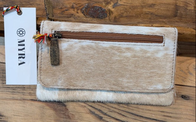 WILDFIRE LEATHER AND HAIRON WALLET on a wood surface with a white myra tag