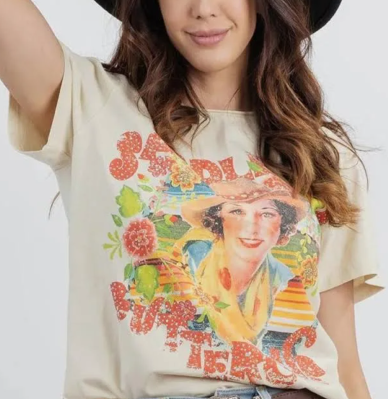Person wearing a t-shirt with a colorful graphic design on a plain background