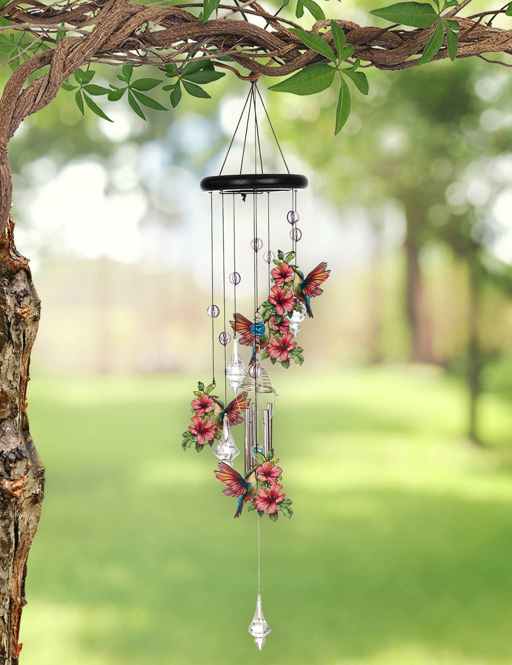 Decorative wind chime with floral and butterfly designs hanging from a tree