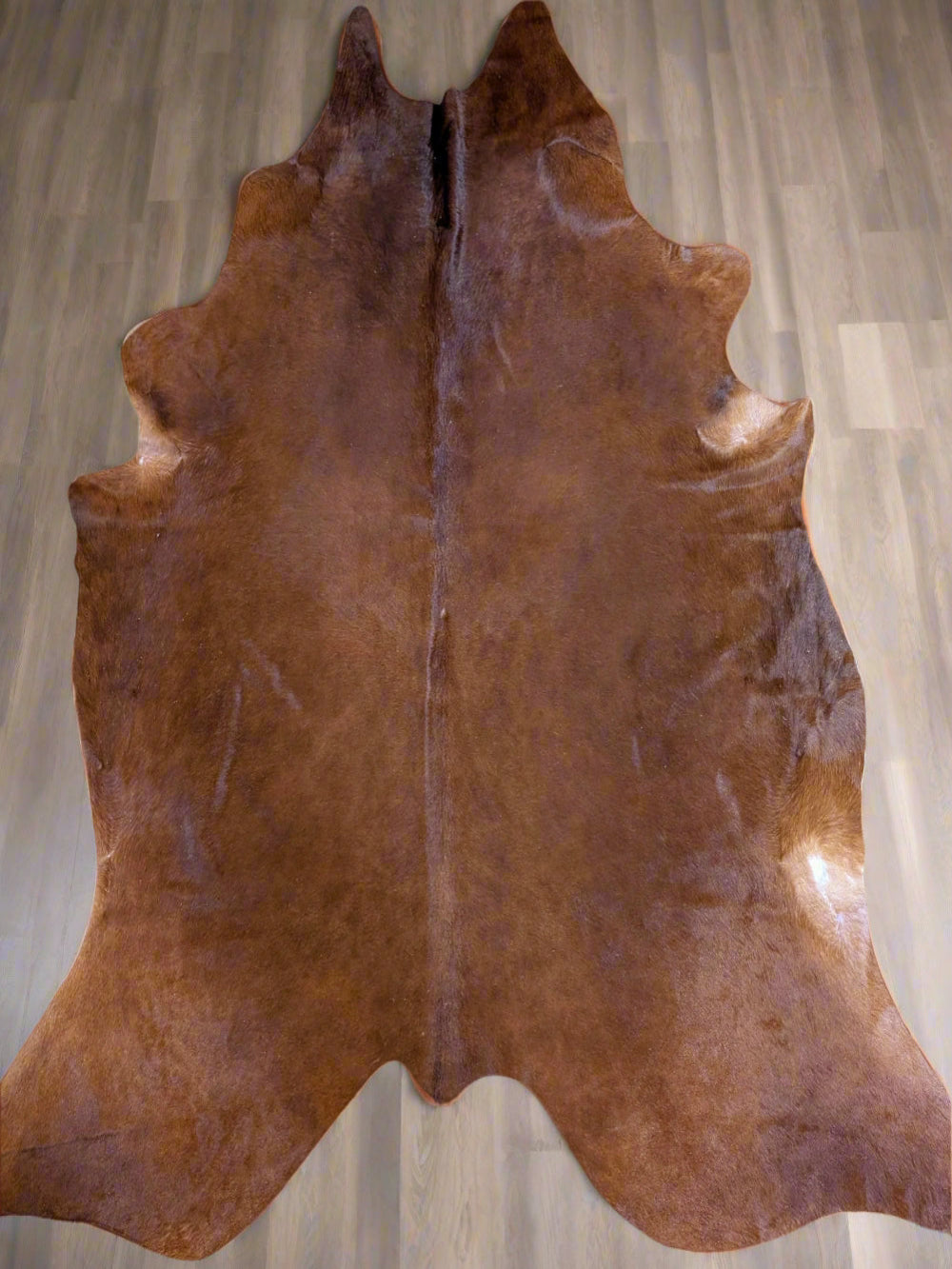 Genuine shiny red cowhide rug with natural texture and rich color