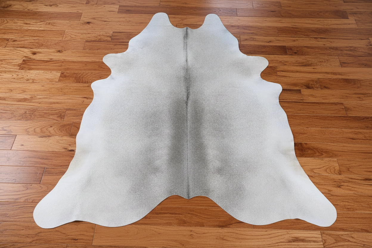 Silver/Gray Cowhide rug on a wood floor