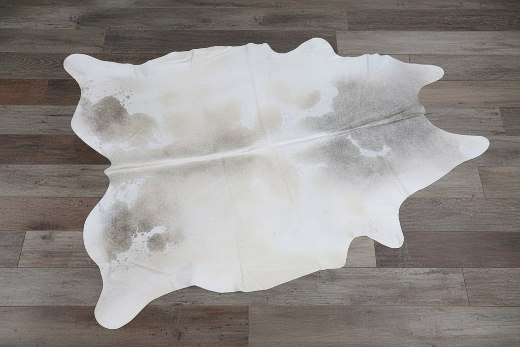 Cowhide rug on a grey wood floor