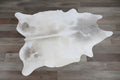 Cowhide rug on a grey wood floor
