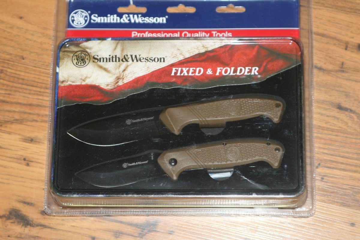 Smith & Wesson fixed and folder knife set in packaging on a wooden surface