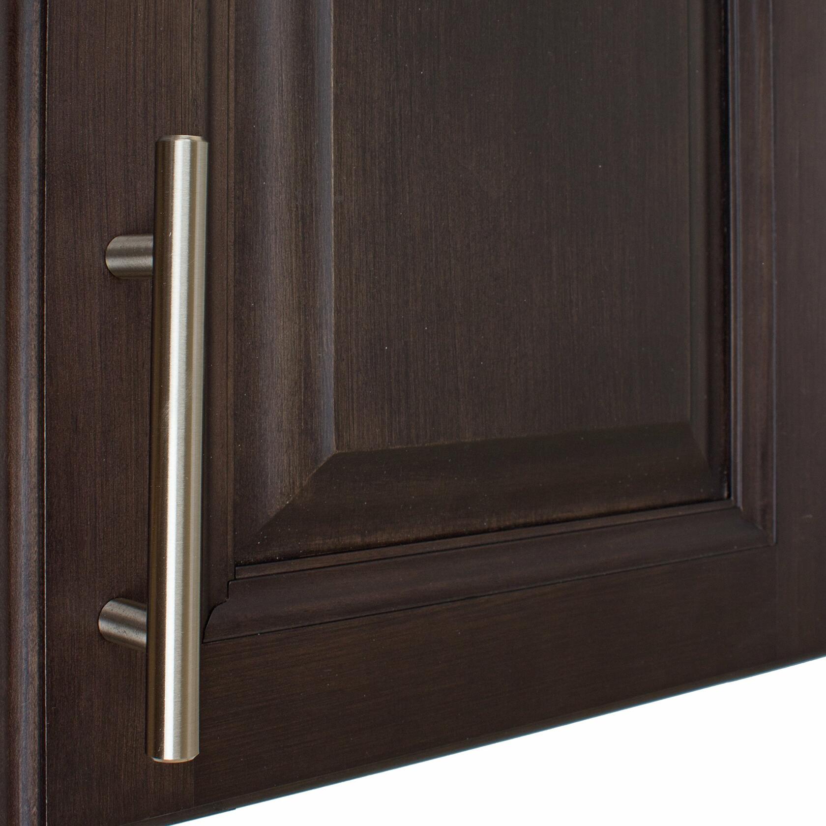 Dark wooden cabinet door with a silver bar handle 