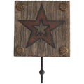 A wall hook with a decorative resin top in the shape of a star, with faux weathered wood plank background and rustic star cut-out, mounted with hardware.