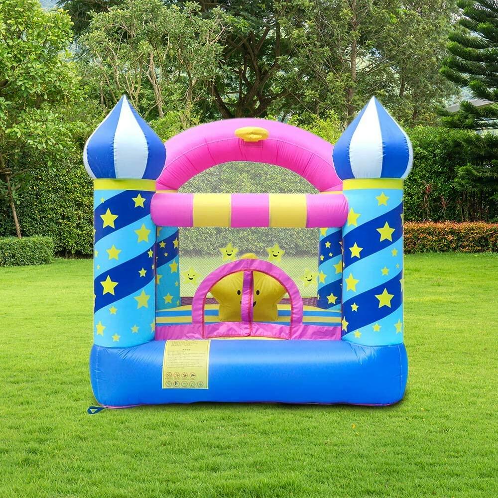 Colorful inflatable castle on a grassy field 