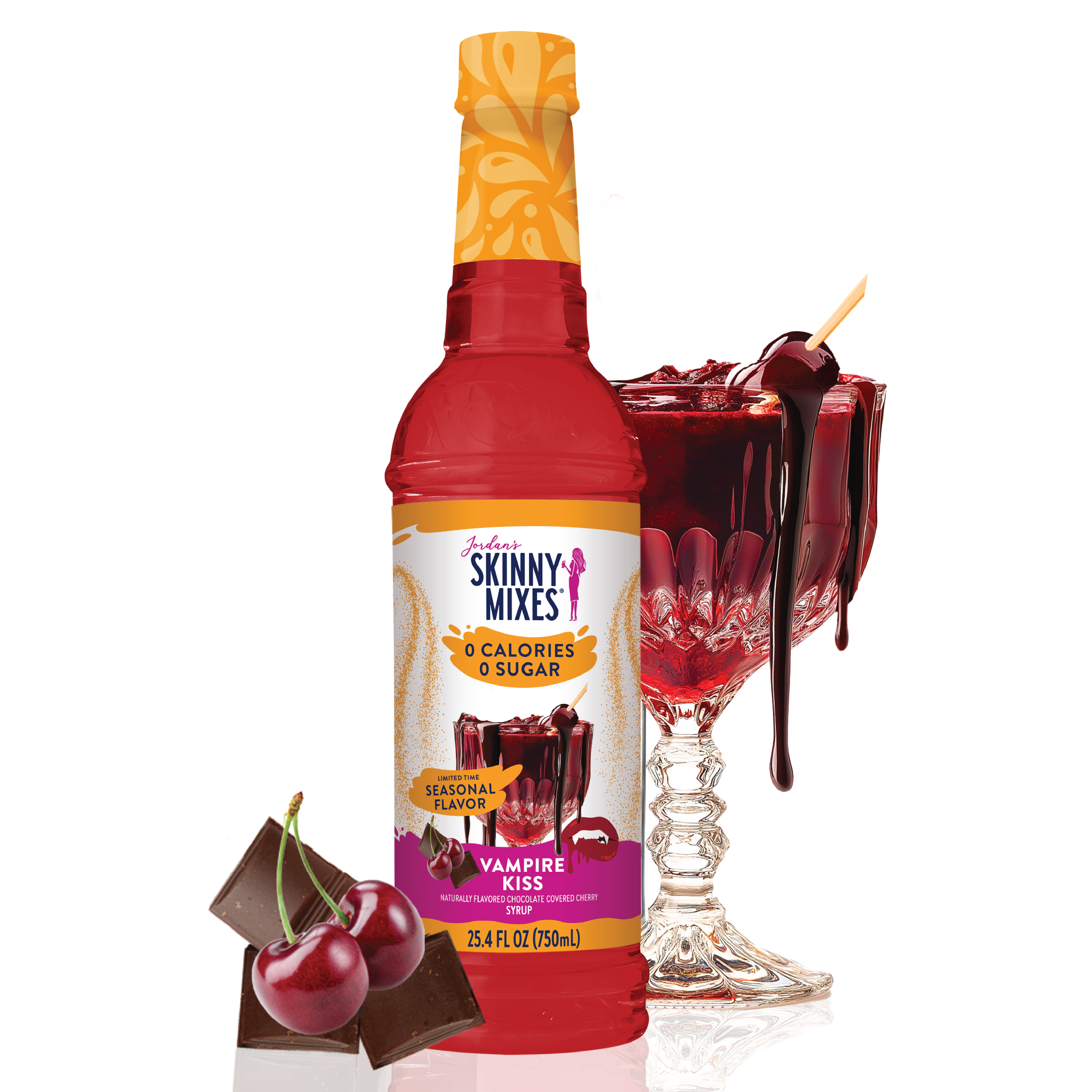 Bottle of Skinny Mixes Vampire Kiss syrup with a glass of red drink and cherries on a white background
