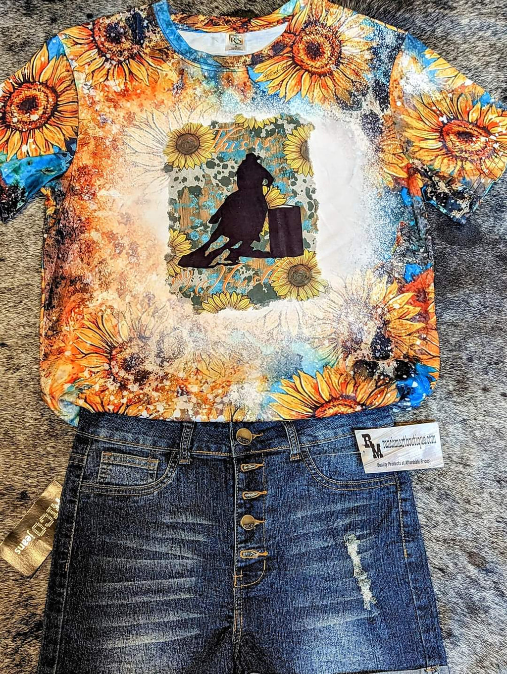 T-shirt with sunflower design and barrel racer and pair shorts on a grey textured background