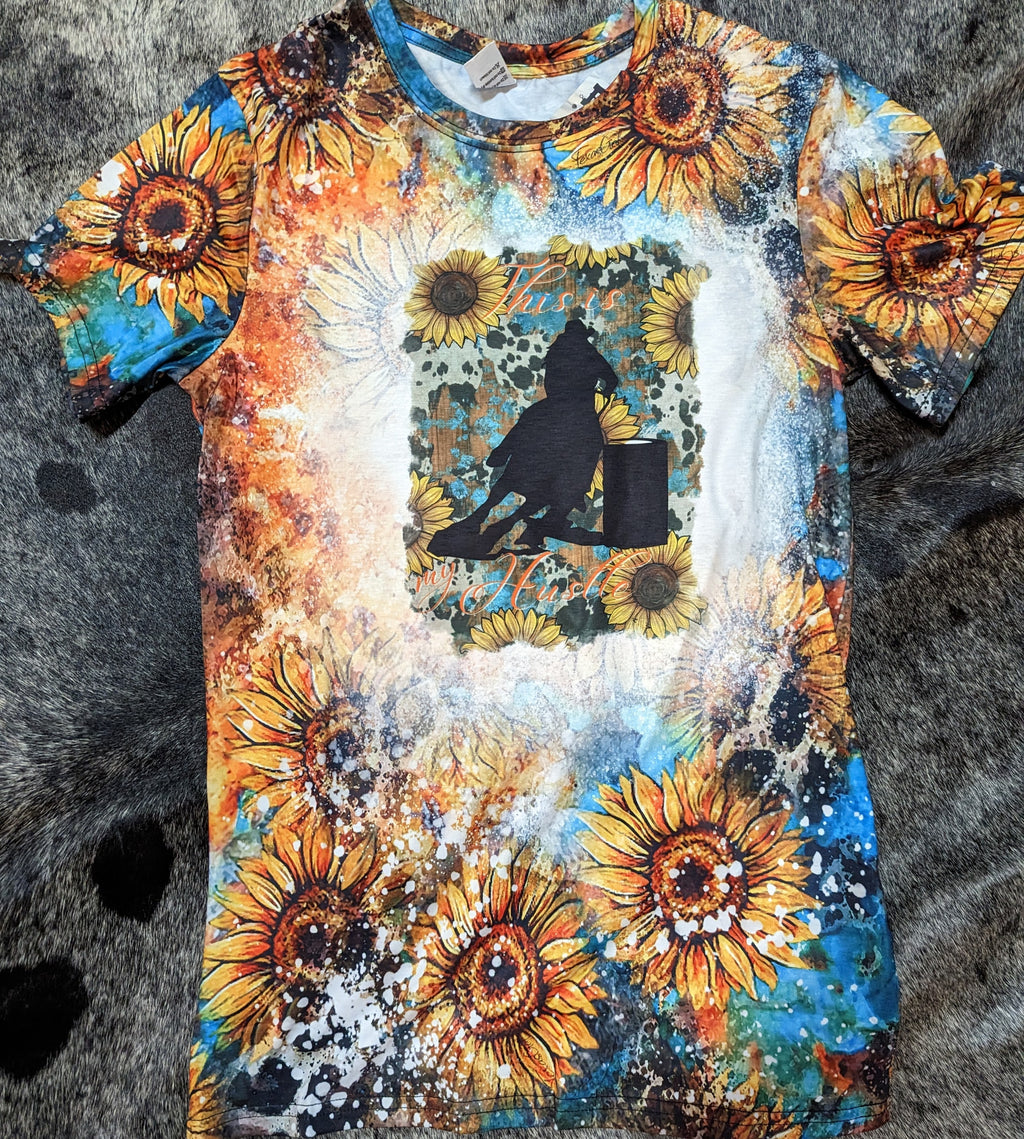 T-shirt with sunflower design and barrel racer on a textured surface