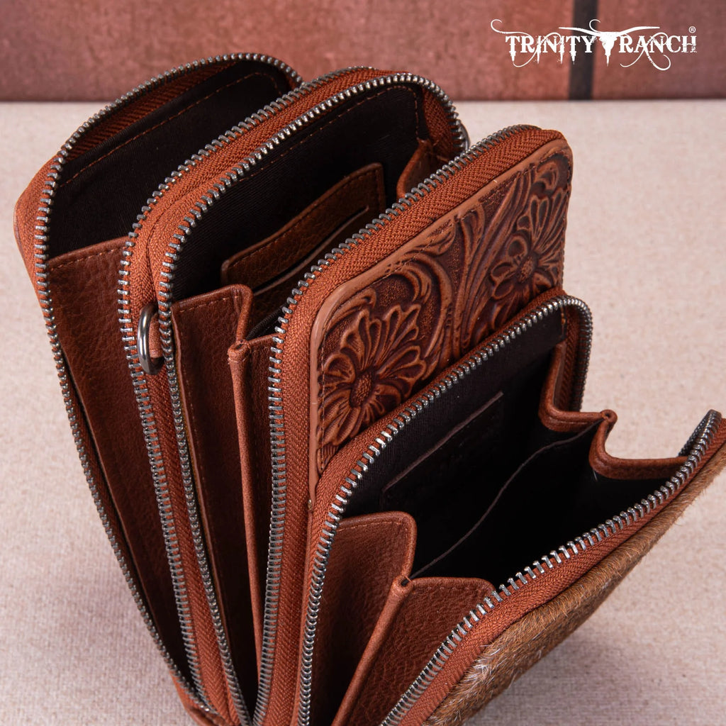 Brown leather wallet with intricate designs and zippers, featuring the Trinity Ranch brand.