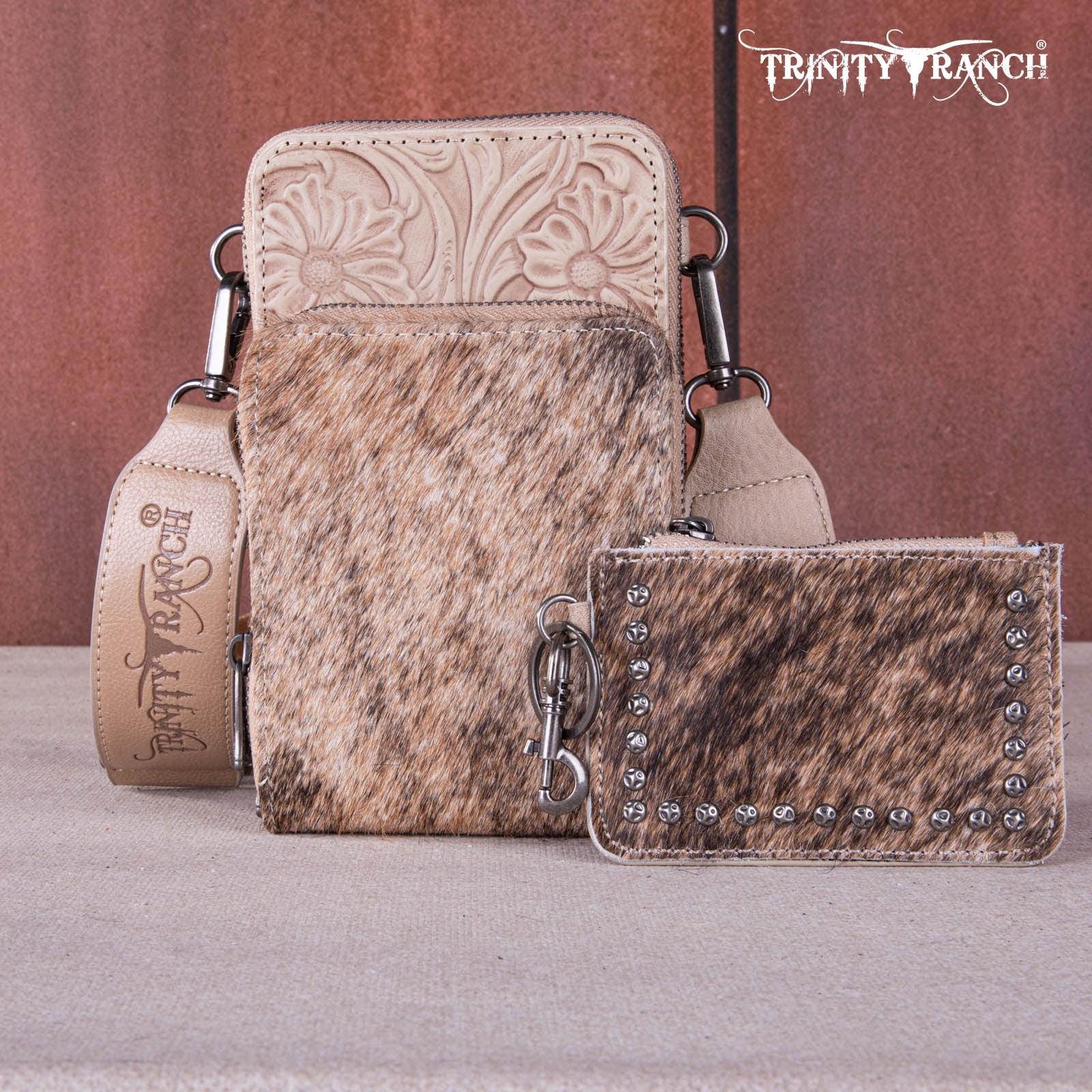 Set of leather bags with intricate designs and 'Trinity Ranch' branding on a neutral background.