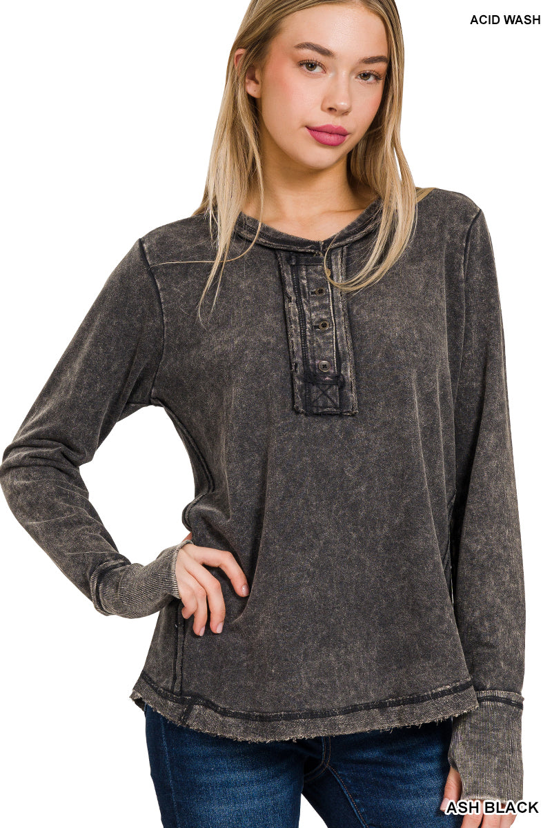Woman wearing an acid wash black long-sleeve shirt on a white background