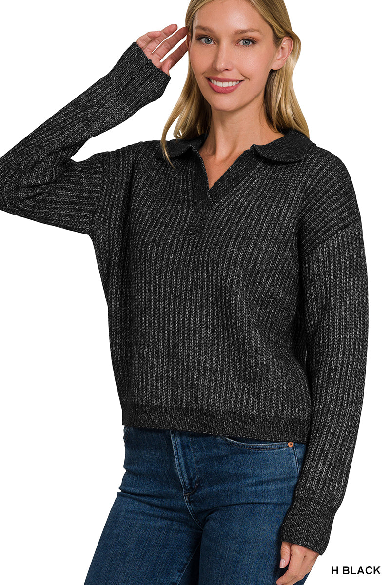 Woman wearing a black sweater with a collar against a white background