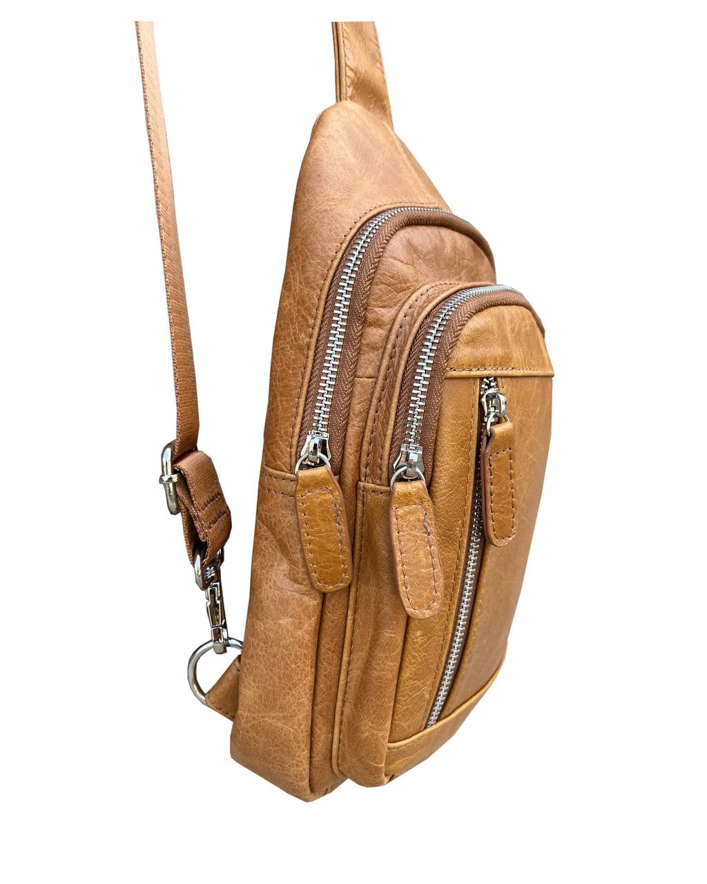 Brown leather crossbody bag with zippers on a white background