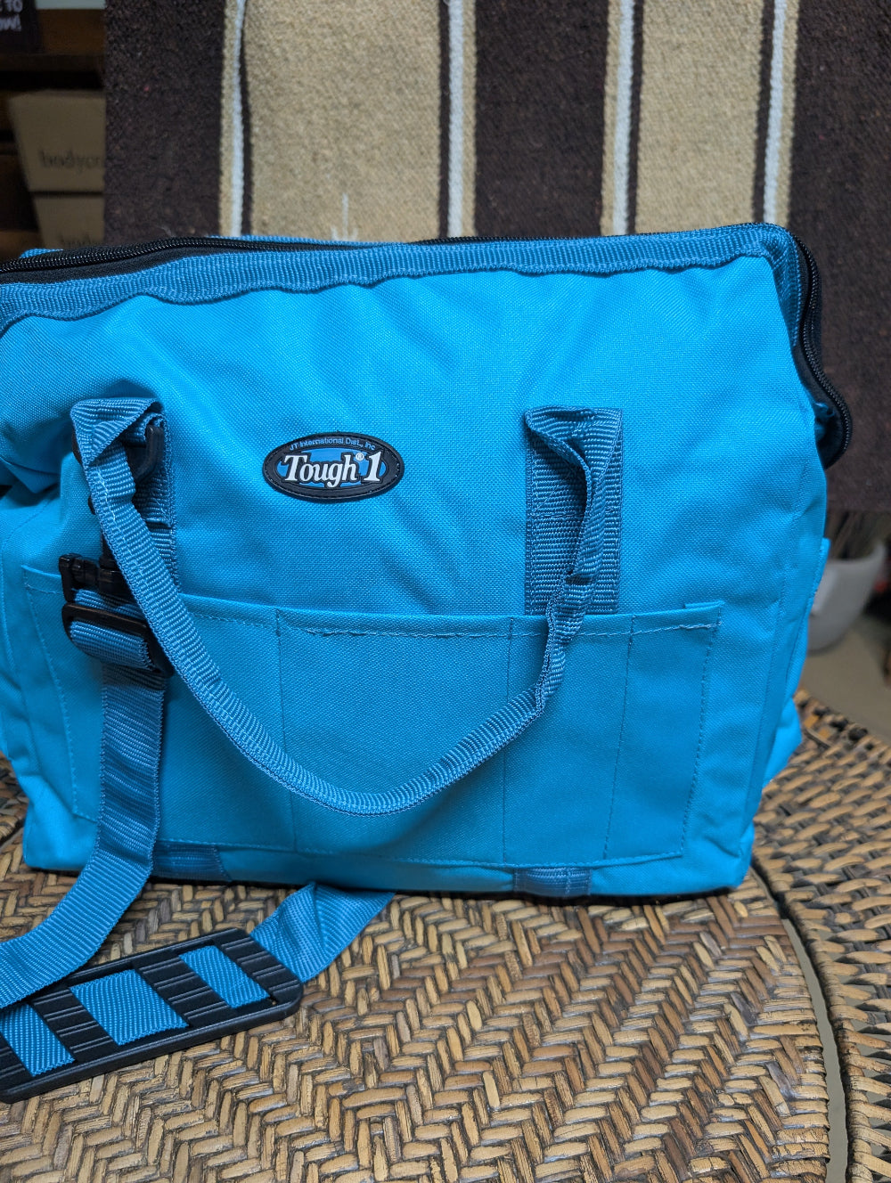 Blue bag with 'Tough 1' logo on a textured surface