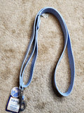 Blue lanyard with a tag on a beige carpet