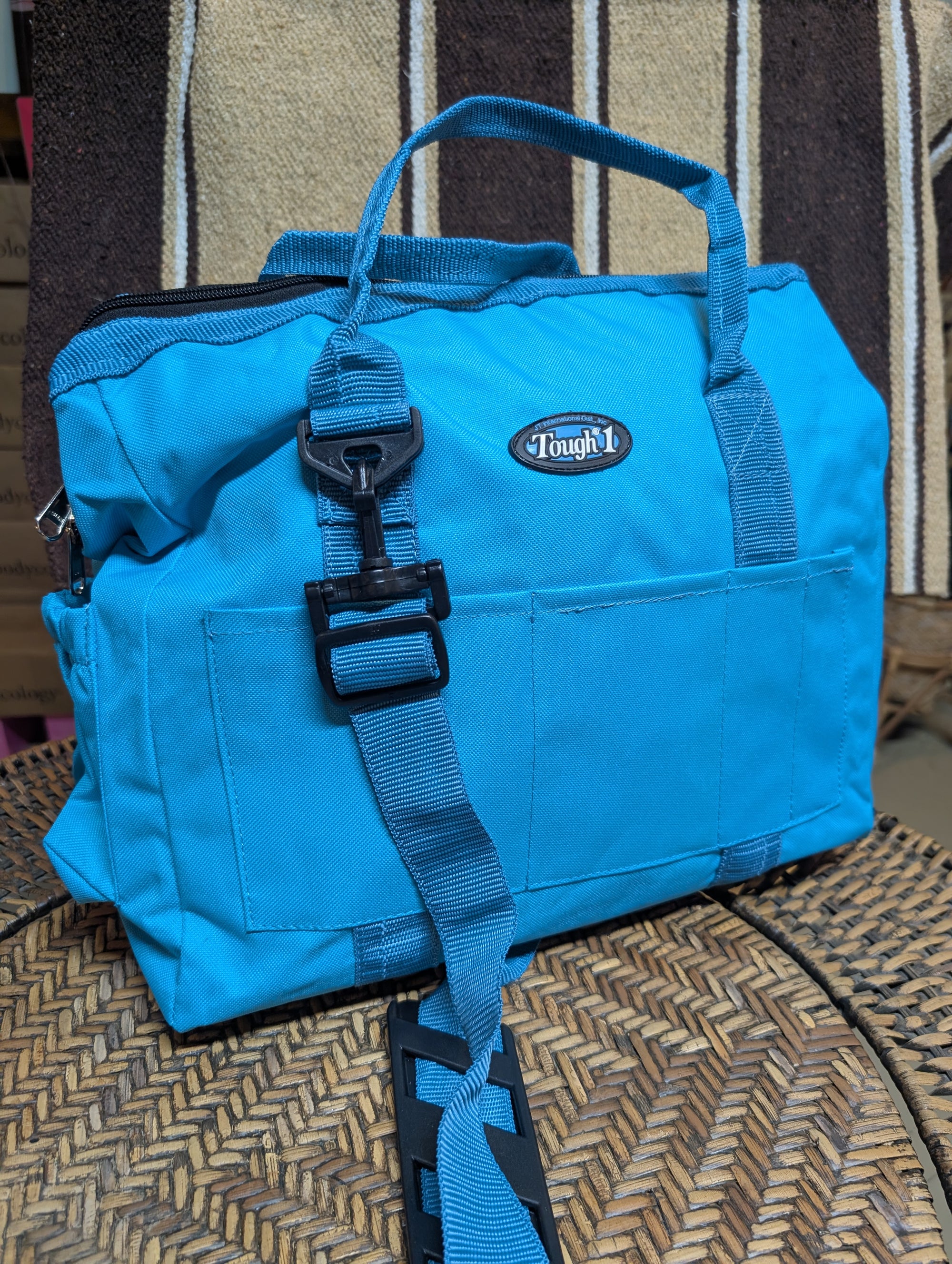 Blue bag with a brand logo on a woven surface