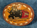 Leather belt buckle with train design and 'Rocky Mountain High' text on a blue textured background