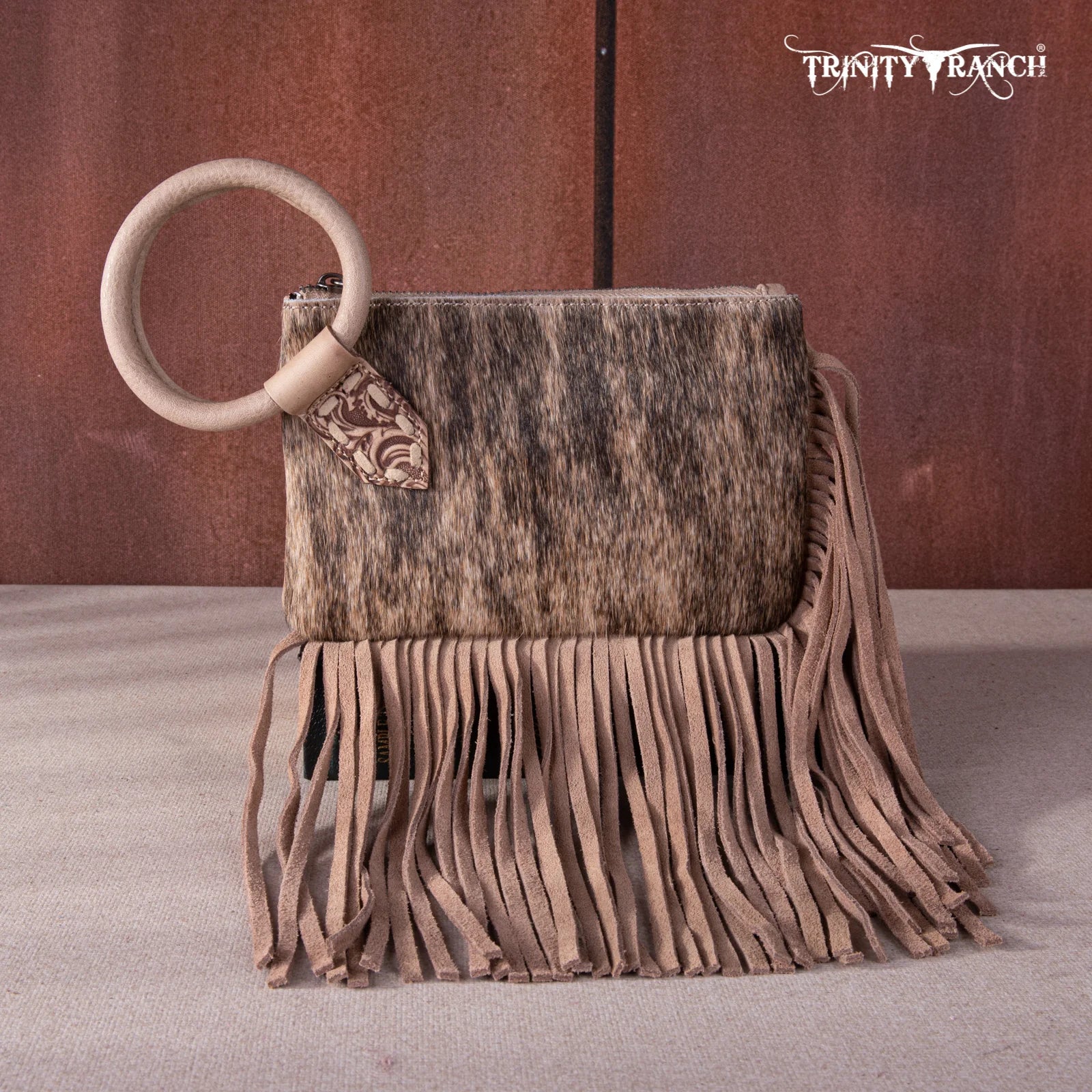 Western-style leather wristlet with real cowhide and zipper closure