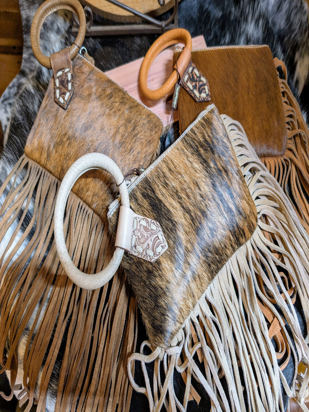 Genuine hair-on cowhide clutch bag with metal ring handle