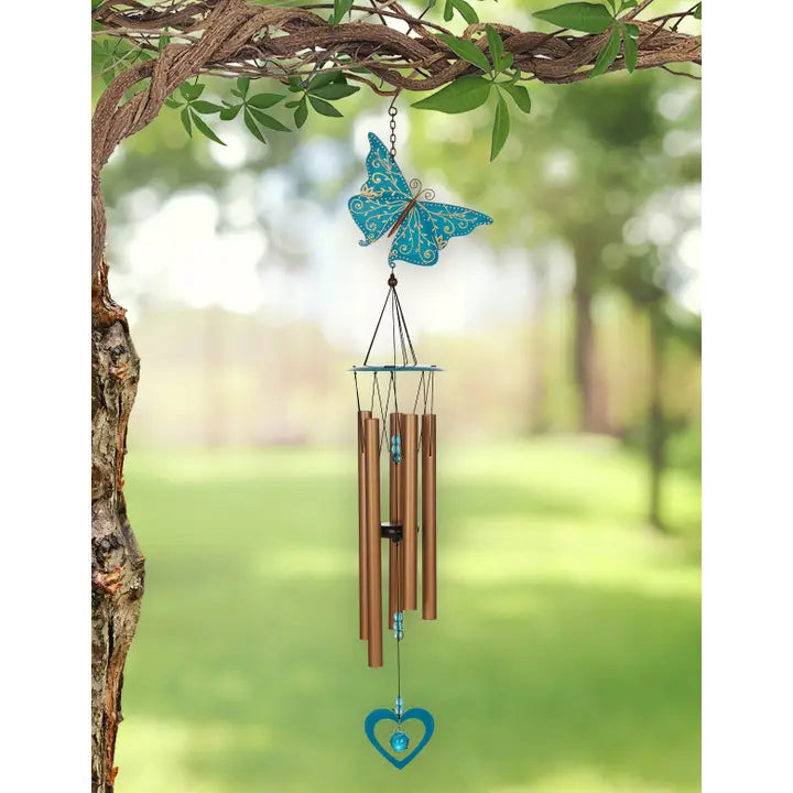 Butterfly-shaped wind chime hanging from a tree branch 