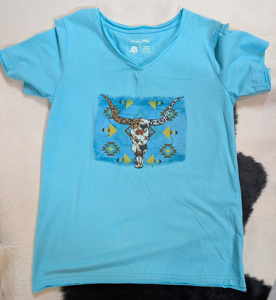 Teal V-Neck Short Sleeve graphic tee with cow skull on a white and black cowhide rug.