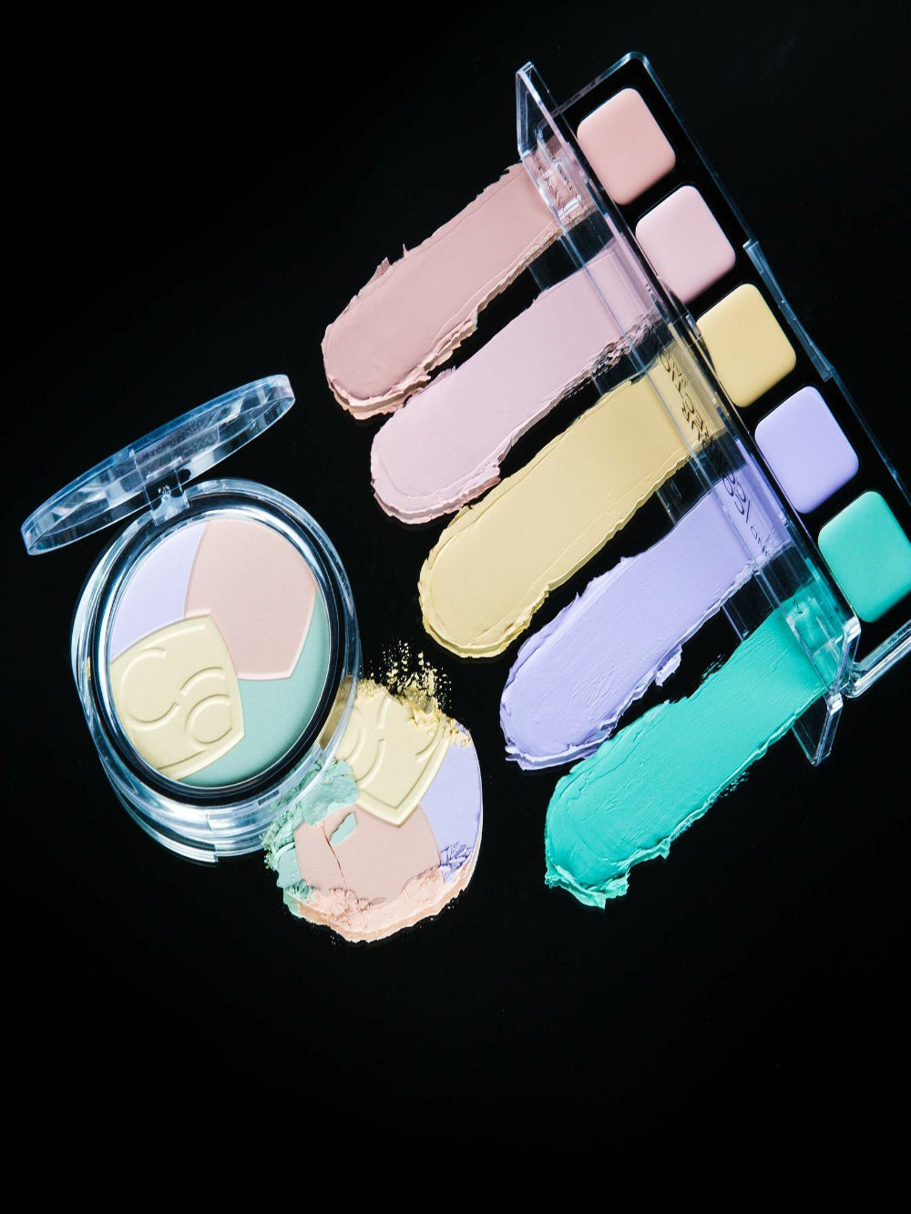 Makeup palette with pastel shades on a black background