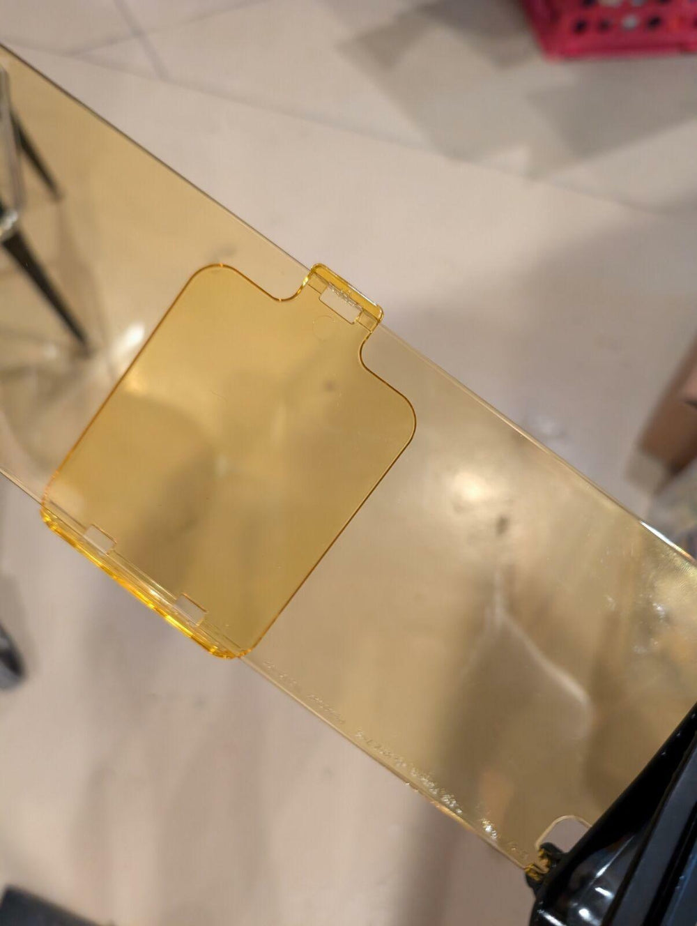 Gold-colored phone case on a reflective surface