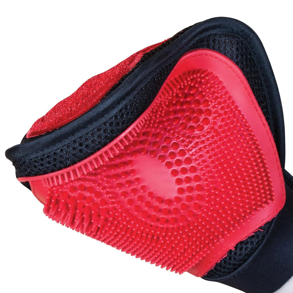 Red and black grooming mitt showing the double sides and the flexibility.