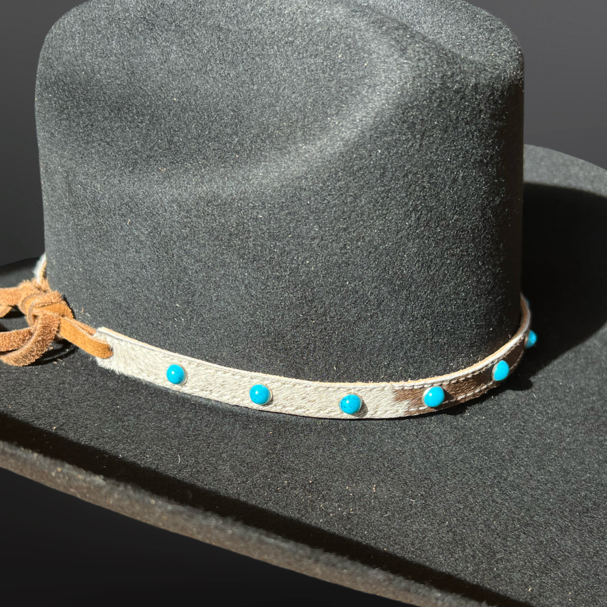 Western Hair-On Band with teal beads on a black hat