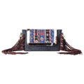 Canvas & Cowhide shoulder bag with fringe with a white background.