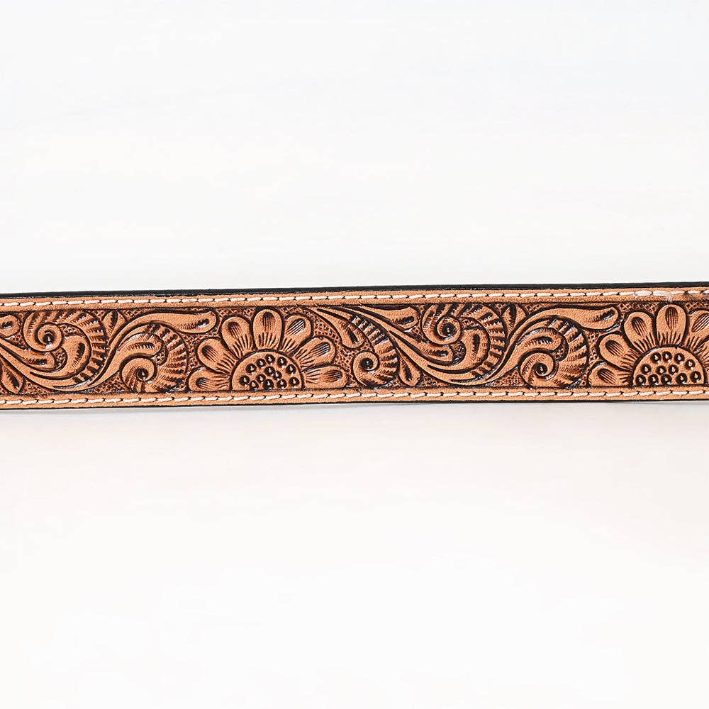 Decorative leather belt with intricate patterns on a white background