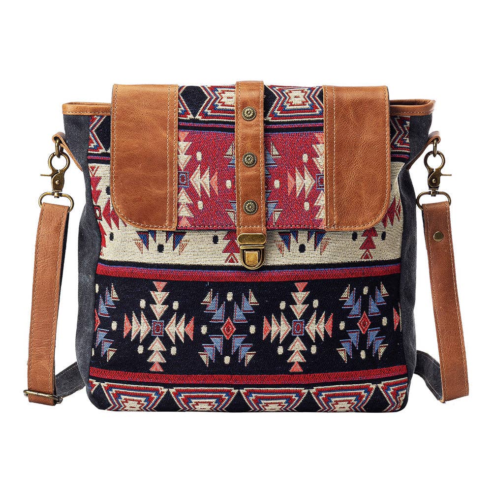 Patterned shoulder bag with brown leather accents on a white background