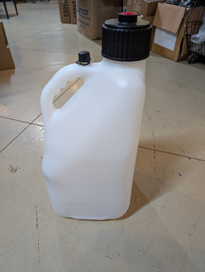 White plastic container with black lid on a tiled floor
