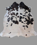 White and Brindle Cowhide rug with a light gray background.