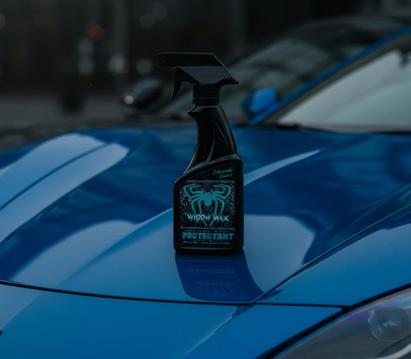 Spray bottle labeled 'Widow Wax' on a hood of a car.