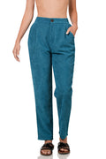 Teal pants worn by a person on a white background
