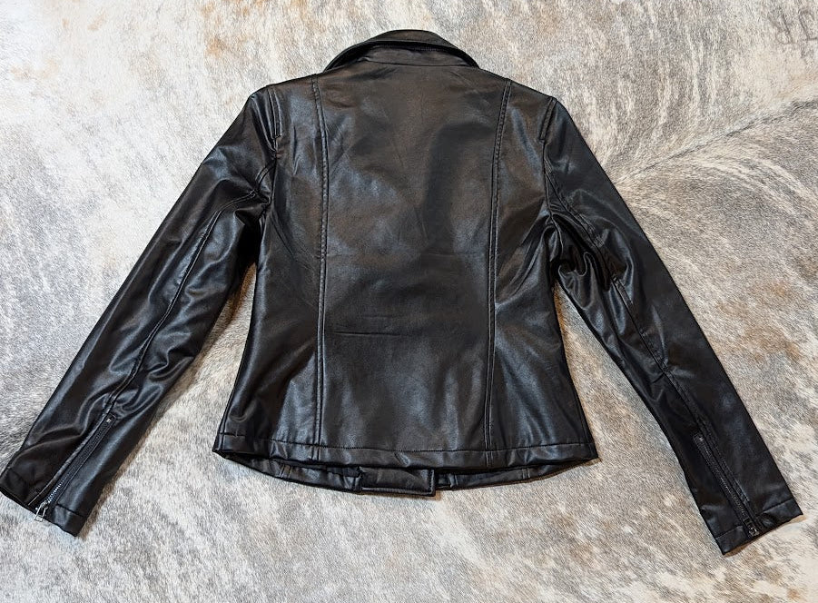 Black leather jacket on a brindle cowhide