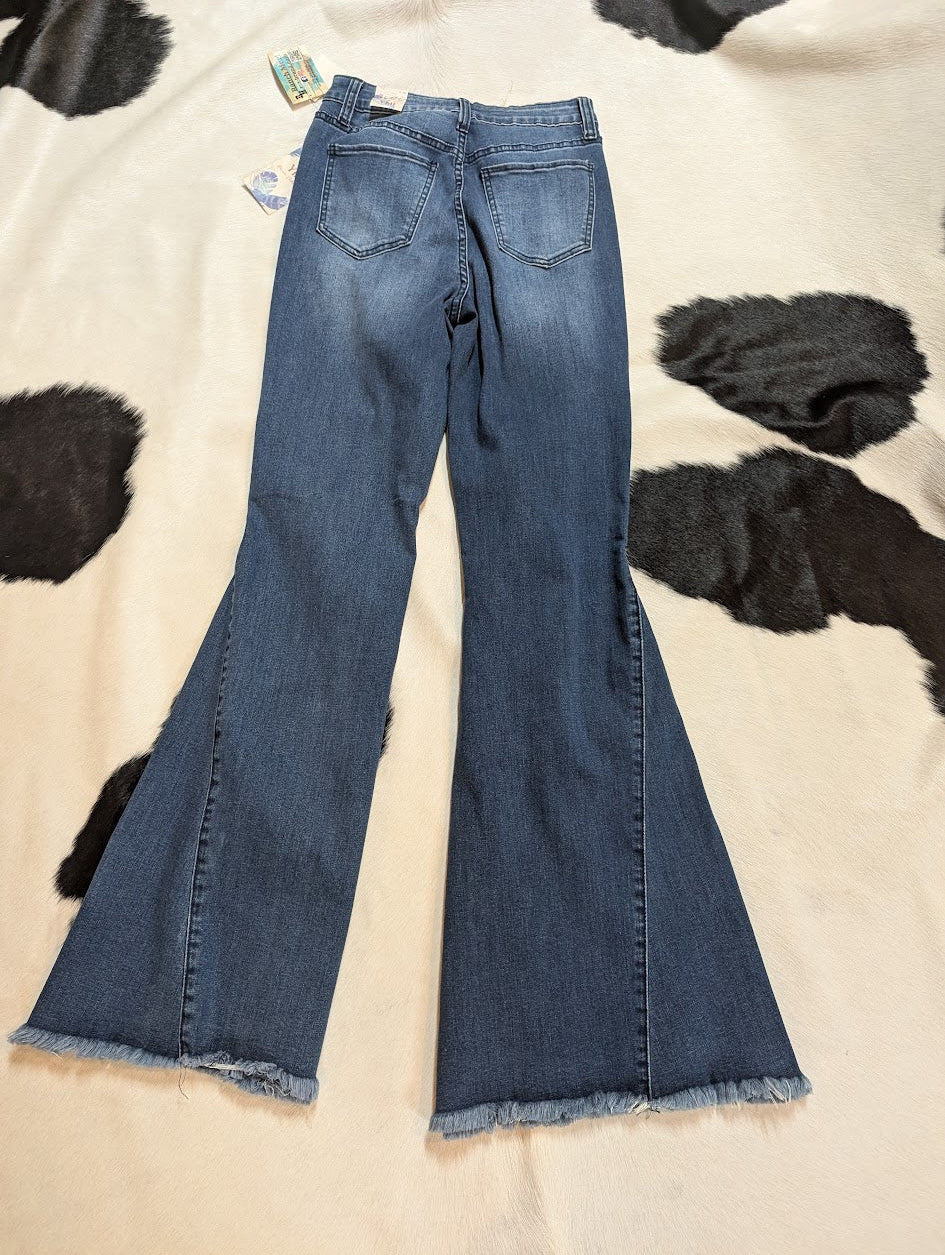 Back view of YMI Women's Jeans Gigi High-Rise Extreme Fit & Flare on a black and white cowhide rug.