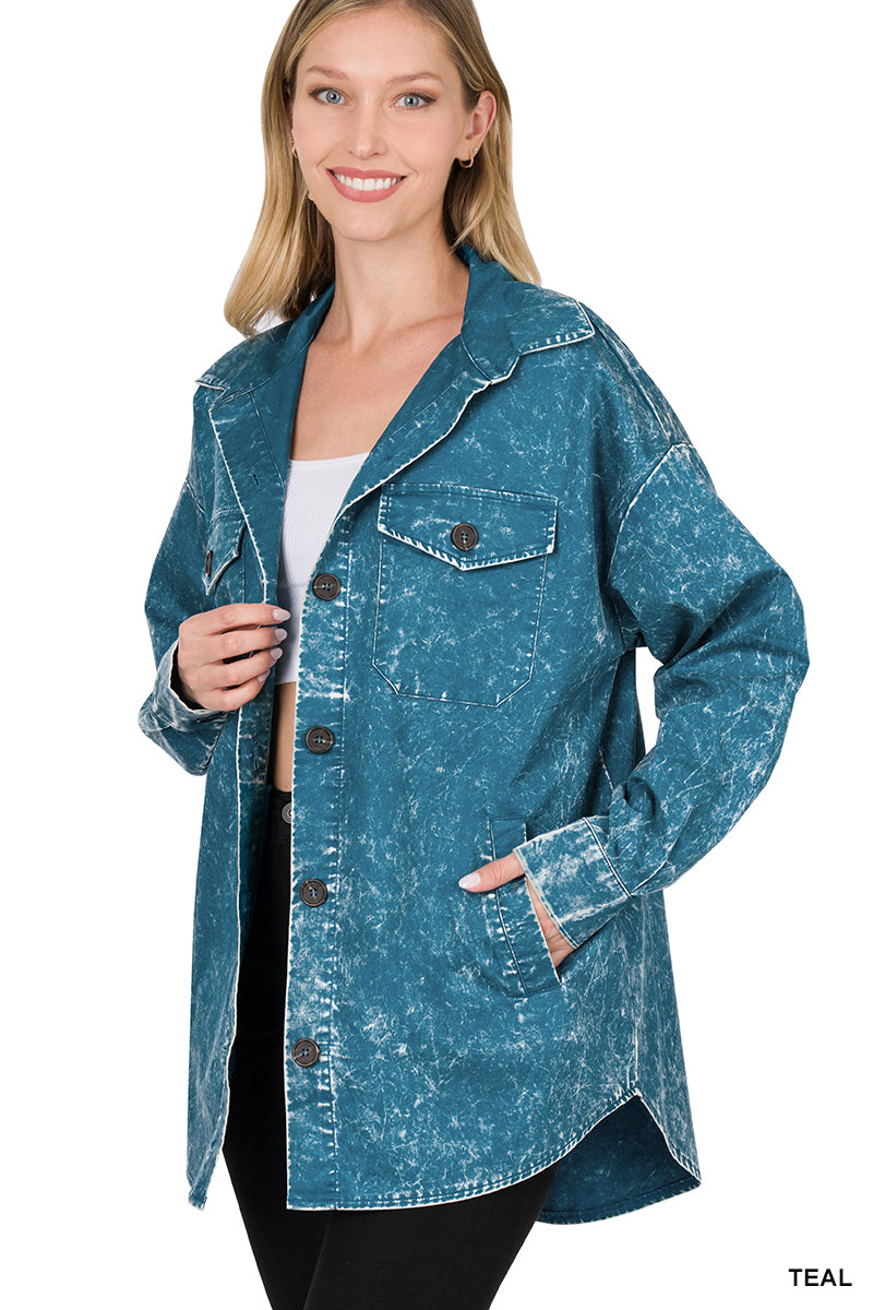 Woman wearing a teal washed shacket on a white background
