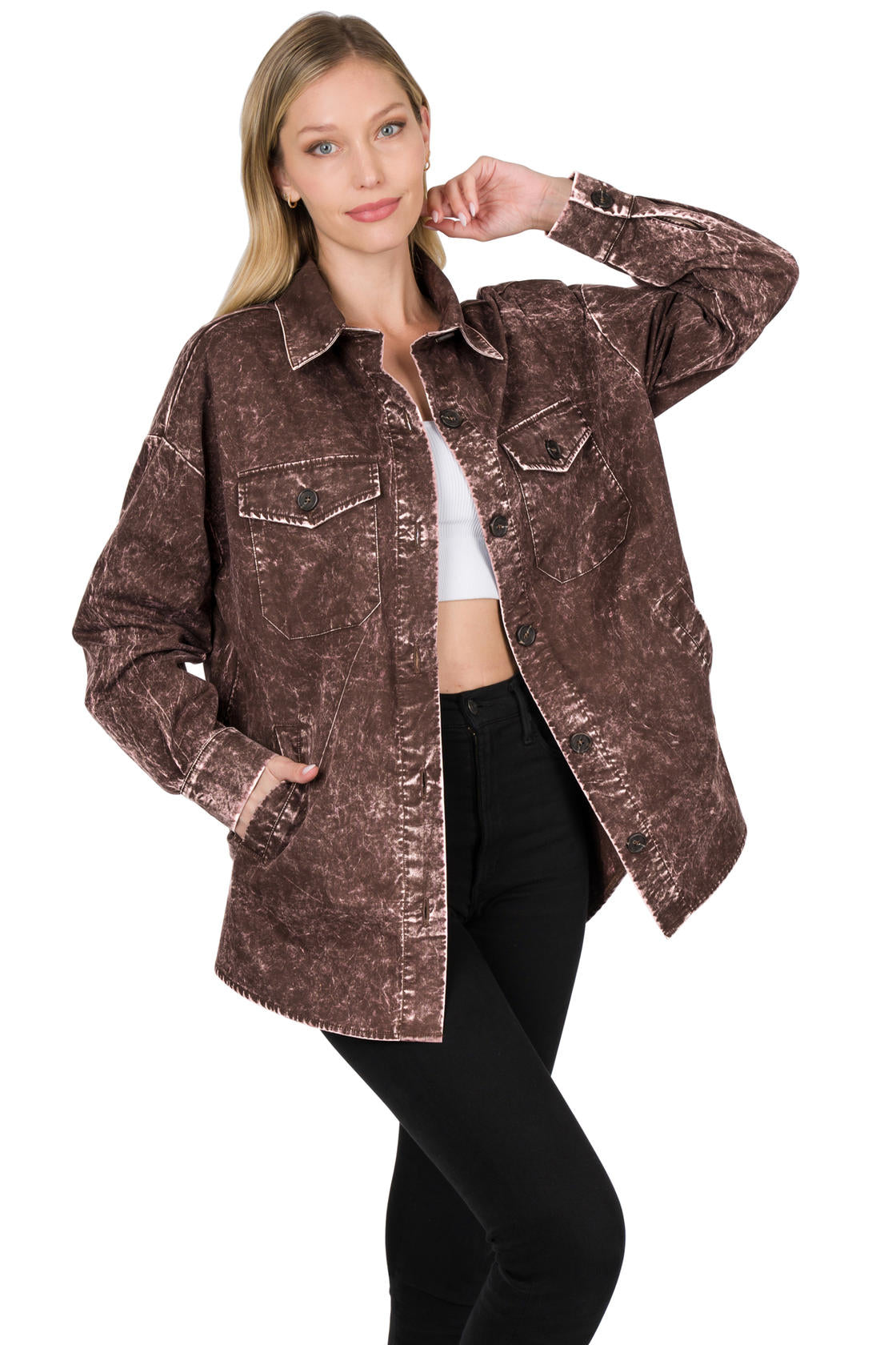Woman wearing a brown acid-wash shacket on a white background